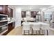 Modern kitchen with stainless steel appliances, dark wood cabinets, and a large center island at 1800 Red Roses Ave, Durham, NC 27703