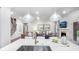 Open concept living area with hardwood floors, a cozy fireplace, and modern decor at 1800 Red Roses Ave, Durham, NC 27703