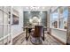 Lovely home office featuring a trendy rug, gray walls, a chandelier, and a large window at 1800 Red Roses Ave, Durham, NC 27703