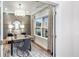 Charming home office with a large window, a modern desk, stylish lighting, and an ornate rug at 1800 Red Roses Ave, Durham, NC 27703