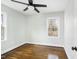 Empty bedroom featuring hardwood floors, a ceiling fan, and two large windows at 2204 Guess Rd, Durham, NC 27705