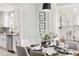 Dining area with seating for six, modern lighting, and view into the updated kitchen at 2204 Guess Rd, Durham, NC 27705