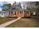 Charming brick home with a well-maintained lawn, dark shutters, and a welcoming front entrance at 2204 Guess Rd, Durham, NC 27705