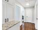 Hallway featuring hardwood floors, white cabinets, and stylish doors at 2204 Guess Rd, Durham, NC 27705
