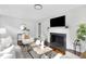 Bright living room features hardwood floors, a fireplace, and modern decor at 2204 Guess Rd, Durham, NC 27705