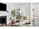 Bright living room featuring a fireplace, stylish decor, and an open view to the dining area at 2204 Guess Rd, Durham, NC 27705
