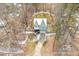 Aerial view of a house in winter, showcasing driveway, roof and surrounding trees at 2209 Woodnell Dr, Raleigh, NC 27603