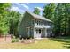 A large backyard with a two-story home surrounded by mature trees at 2209 Woodnell Dr, Raleigh, NC 27603