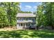 A large backyard features a well-manicured lawn and lush, mature trees at 2209 Woodnell Dr, Raleigh, NC 27603