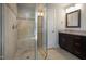 Bathroom featuring an enclosed shower, dark cabinets, and granite countertops at 2209 Woodnell Dr, Raleigh, NC 27603