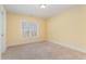 Bright, carpeted bedroom features large window and neutral tones at 2209 Woodnell Dr, Raleigh, NC 27603