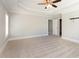 A cozy carpeted primary bedroom featuring large open space, a ceiling fan, and a walk-in closet at 2209 Woodnell Dr, Raleigh, NC 27603