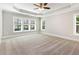 Carpeted main bedroom featuring a ceiling fan and big windows for a view at 2209 Woodnell Dr, Raleigh, NC 27603