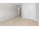 An open bedroom with neutral walls and flooring, showing the entrance to the closet at 2209 Woodnell Dr, Raleigh, NC 27603