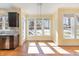 Bright breakfast nook with hardwood floors, large windows, and modern lighting at 2209 Woodnell Dr, Raleigh, NC 27603