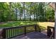 A wooden deck with a view of a large, well-maintained backyard at 2209 Woodnell Dr, Raleigh, NC 27603