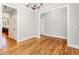 Open floor plan dining room with hardwood floors and modern lighting fixture at 2209 Woodnell Dr, Raleigh, NC 27603