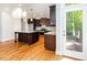 Spacious kitchen features dark wood cabinets, granite countertops, stainless steel appliances, and a central island at 2209 Woodnell Dr, Raleigh, NC 27603