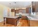 Kitchen features a granite countertop island, stainless steel appliances, and dark wood cabinets at 2209 Woodnell Dr, Raleigh, NC 27603