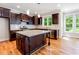 Modern kitchen with dark wood cabinets, granite countertops, and stainless steel appliances at 2209 Woodnell Dr, Raleigh, NC 27603