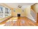 Open living area with a fireplace, large windows, and a staircase leading upstairs at 2209 Woodnell Dr, Raleigh, NC 27603