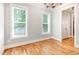 Bright living room showcasing hardwood floors, two large windows, and neutral wall color at 2209 Woodnell Dr, Raleigh, NC 27603
