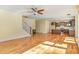 Expansive living space featuring hardwood floors, staircase, and an adjacent kitchen at 2209 Woodnell Dr, Raleigh, NC 27603