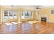 Spacious living room with hardwood floors, fireplace, and large windows offering outdoor views at 2209 Woodnell Dr, Raleigh, NC 27603