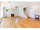 Bright living room with hardwood floors, fireplace, ceiling fan, and staircase at 2209 Woodnell Dr, Raleigh, NC 27603