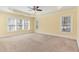 Spacious main bedroom with tray ceiling, ceiling fan, and multiple windows at 2209 Woodnell Dr, Raleigh, NC 27603