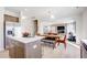 Open kitchen view featuring stainless steel appliances, a center island, and an adjacent living room at 230 Deodora Ln, Cameron, NC 28326