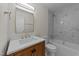 Bathroom features a shower-tub combo, a vanity, and a large mirror at 2908 Basswood Dr, Raleigh, NC 27610