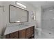 Bathroom boasts a shower and vanity with a brown cabinet and white countertop at 2908 Basswood Dr, Raleigh, NC 27610