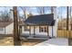 Charming renovated bungalow with a gray front porch and a new driveway at 2908 Basswood Dr, Raleigh, NC 27610