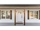 Up close view of renovated bungalow style home with a gray front porch and wood accent features at 2908 Basswood Dr, Raleigh, NC 27610