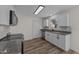Renovated kitchen with stainless steel appliances, white cabinets, grey countertops, and modern backsplash at 2908 Basswood Dr, Raleigh, NC 27610