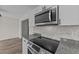 Close up view of stainless steel microwave and glass top range in updated kitchen at 2908 Basswood Dr, Raleigh, NC 27610