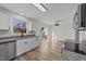 Spacious kitchen with stainless steel appliances, white cabinetry, granite counters, and slider access to the deck at 2908 Basswood Dr, Raleigh, NC 27610
