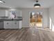 Modern kitchen and dining area with stainless steel appliances, white cabinets, and sliding door access to deck at 2908 Basswood Dr, Raleigh, NC 27610