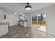 New kitchen with stainless steel appliances, sliding glass door to the deck, and luxury vinyl plank floors at 2908 Basswood Dr, Raleigh, NC 27610