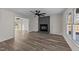 Bright living room featuring luxury vinyl plank flooring and a painted brick fireplace at 2908 Basswood Dr, Raleigh, NC 27610