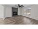 Bright living room featuring luxury vinyl plank flooring and a painted brick fireplace at 2908 Basswood Dr, Raleigh, NC 27610