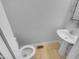 Bathroom with pedestal sink, toilet and neutral color paint at 3300 Mossdale Ave, Durham, NC 27707