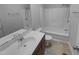Bathroom with a single sink vanity and a bathtub-shower combination with a white shower curtain at 3300 Mossdale Ave, Durham, NC 27707