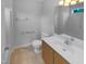 Bathroom with wood cabinets, tile floors, toilet, bathtub and framed mirror at 3300 Mossdale Ave, Durham, NC 27707