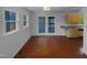 Bright dining area with hardwood floors, natural light and french doors leading to the outdoor deck at 3300 Mossdale Ave, Durham, NC 27707