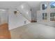 Open-concept living area with vaulted ceilings, stairs, hardwood floors, carpet and many windows for natural light at 3300 Mossdale Ave, Durham, NC 27707