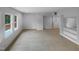 Spacious living room with neutral carpet, baseboard trim, big windows and plenty of natural light at 3300 Mossdale Ave, Durham, NC 27707