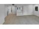 Carpeted living room with door leading to the backyard and walk-in closet at 3300 Mossdale Ave, Durham, NC 27707