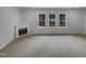 Cozy living room featuring large windows and a fireplace at 3300 Mossdale Ave, Durham, NC 27707